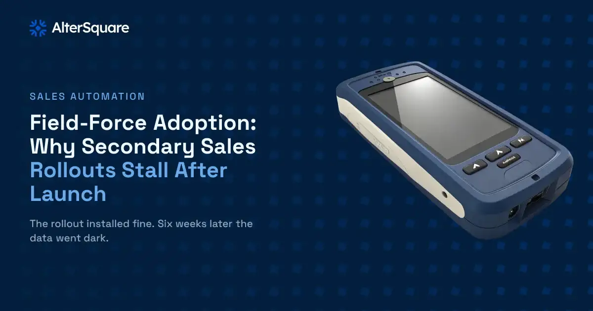 A powered-off rugged handheld sales device left face-down on a warehouse surface, screen dark and unused